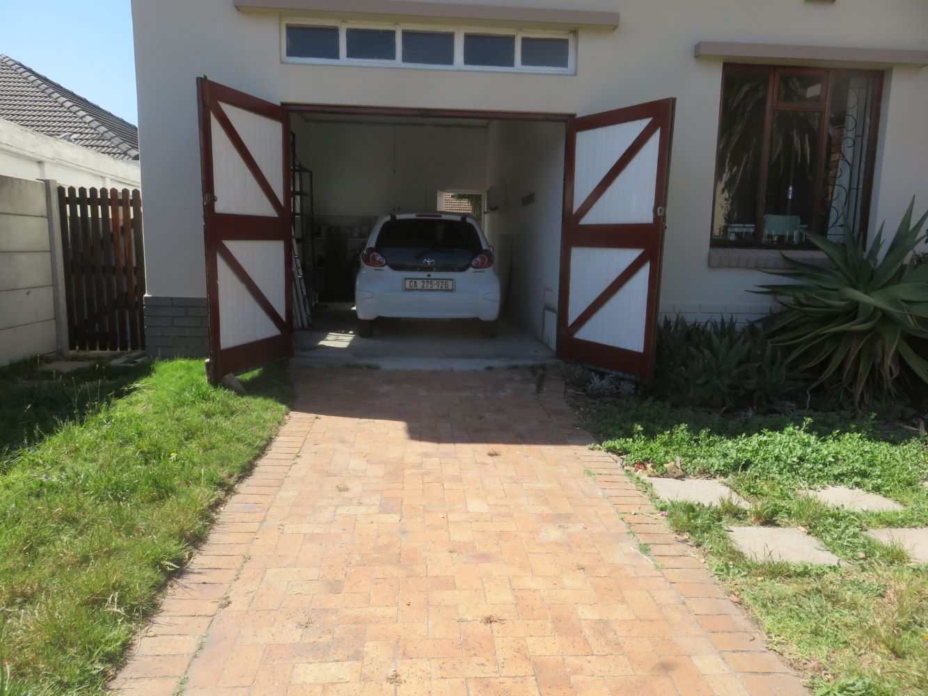 The house at Zandvlei has a massive garage in which two cars can fit end to end. The drive and front garden can accommodate another two.