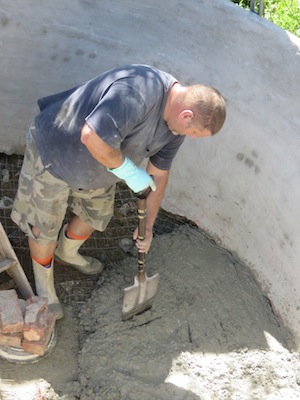 Marc moves the wet concrete