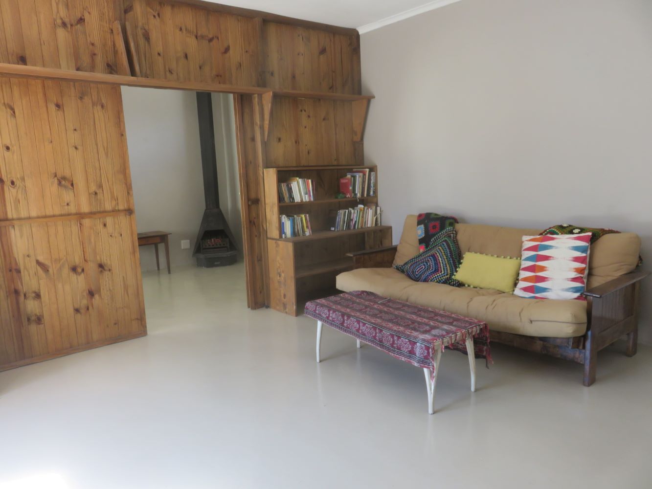 The main lounge at Zandvlei. A wooden screen can be drawn across to give the granny flat lounge with its jet-master fireplace privacy.