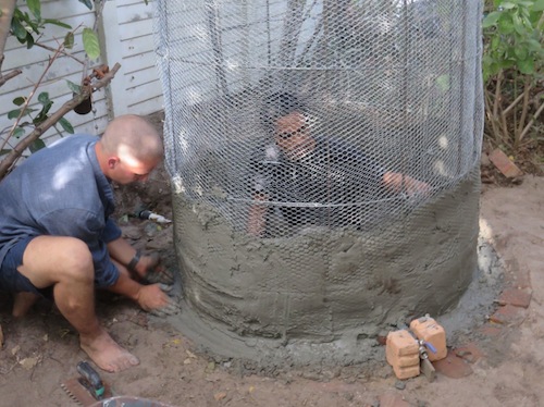 Two plasterers pressing from opposite sides of the mesh works well