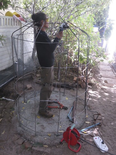 Imraan stands on the base that was cast in Day 1, fixing on the horizontals