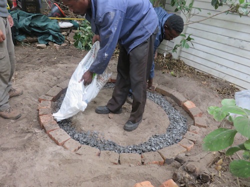 Elias neatly fills stone in trench