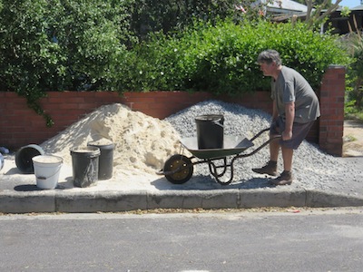carting stone and sand from street to pond