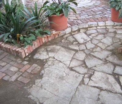 cracked concrete slabs transition into cement shatter paving