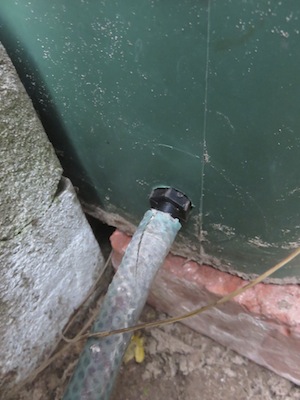a flexible hose on a rain bin allows storage and easy targeted watering when needed